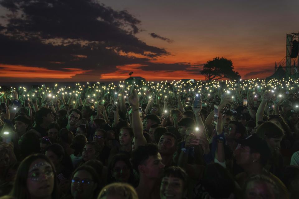 Music fans attend the "Here we are" festival, in celebration of Women's History Month, in Montevideo, Uruguay, March 19, 2023. (AP Photo/Matilde Campodonico)