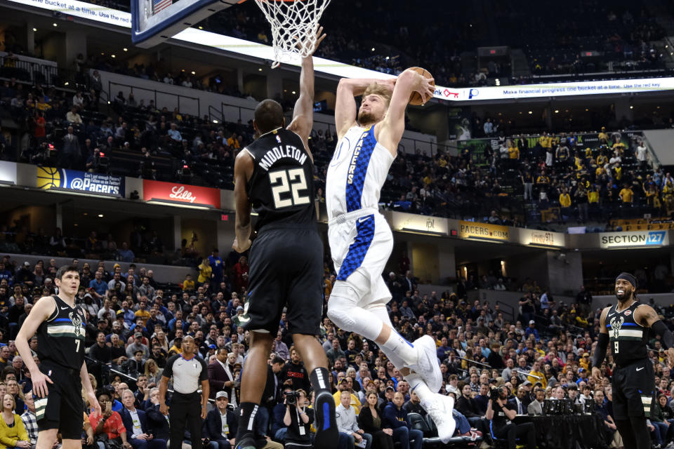 Indiana Pacers forward Domantas Sabonis (11) goes up to the basket as Milwaukee Bucks forward Khris Middleton (22) defends during the first half of an NBA basketball game in Indianapolis, Wednesday, Feb. 12, 2020. (AP Photo/AJ Mast)