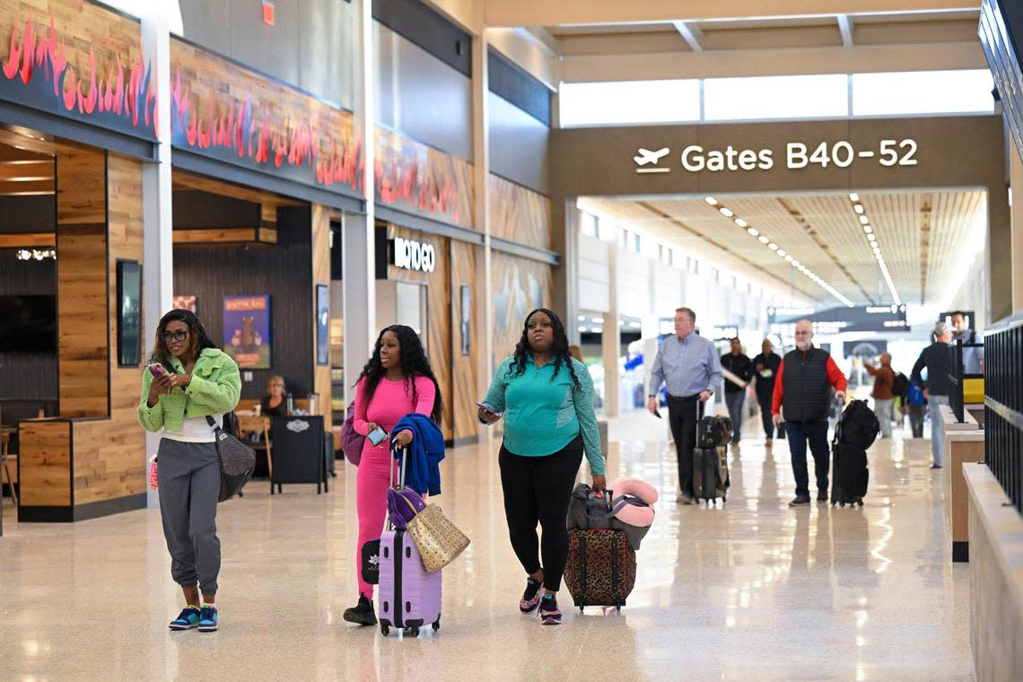 Passengers Jonae Garrett, from left, Diamonique Porter and Keyona Sanders, all of Kansas City, Kansas, walked to their gate for a departure to Hawaii on Tuesday, Feb. 28, 2023, at the new $1.5 billion single terminal at Kansas City International Airport.