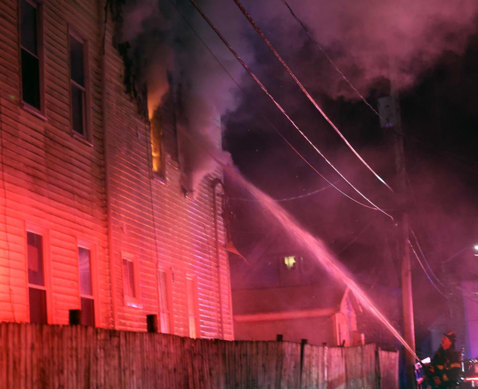 Brockton firefighters battle a three-alarm house fire at 25 Central Square on Sunday, Feb. 12, 2023.