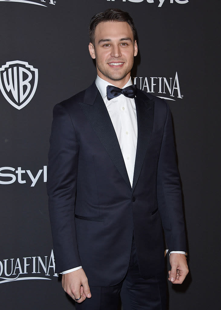 Ryan Guzman in front of a step and repeat