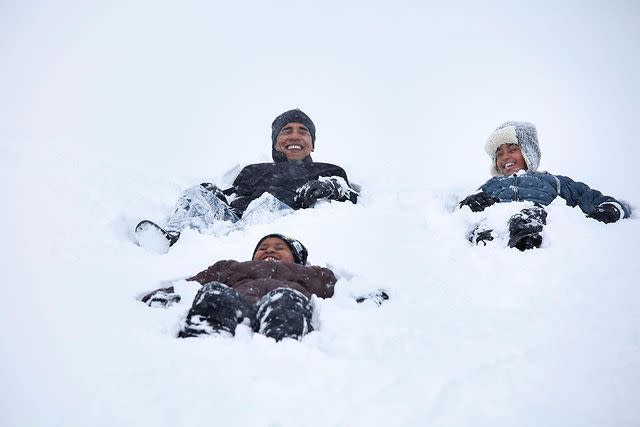 <p>Obama enjoys some winter fun with his little snow angels in this throwback photo. </p>