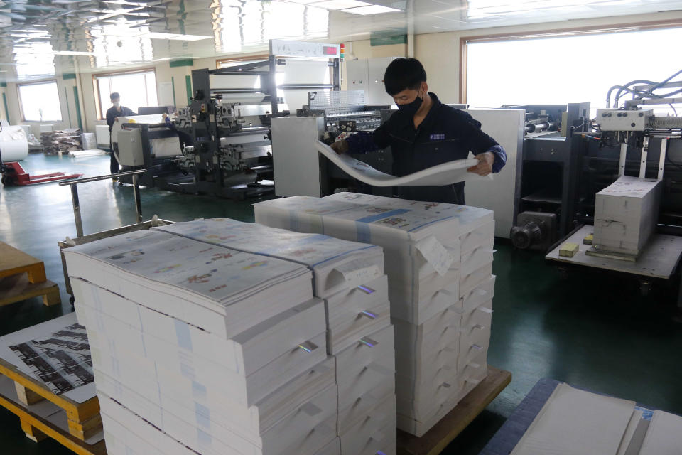 An employee at the Mindulle Notebook Factory assembles notebooks in a larger quantity to pupils and students across the country in Pyongyang, North Korea, Thursday, Nov. 12, 2020. North Korea is staging an “80-day battle,” a propaganda-heavy productivity campaign meant to bolster its internal unity and report greater production in various industry sectors ahead of a ruling party congress in January. (AP Photo/Jon Chol Jin)