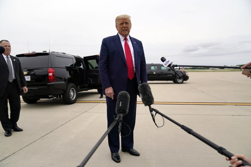 President Donald Trump talks to reporters as he arrives at Waukegan National Airport in Waukegan, Ill., on his way to visit Kenosha, Wis., Sept. 1, 2020, in Kenosha. (AP Photo/Evan Vucci)
