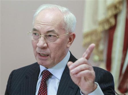 Ukraine's Prime Minister Mykola Azarov gestures during a meeting with foreign journalists in Kiev November 26, 2013. REUTERS/Gleb Garanich