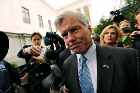 Former Virginia Governor Bob McDonnell is trailed by reporters as he departs after his appeal of his 2014 corruption conviction was heard at the U.S. Supreme Court in Washington, U.S. April 27, 2016. REUTERS/Jonathan Ernst