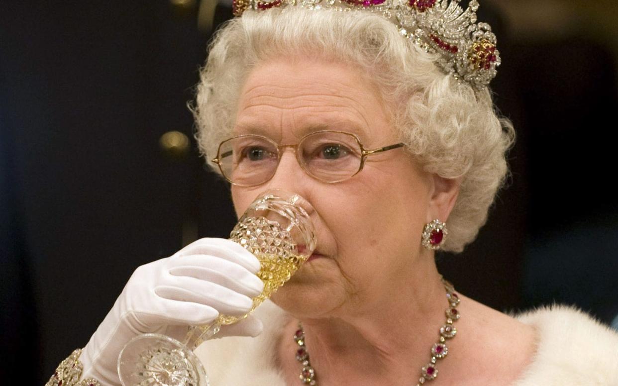The Queen sips Champagne during a visit to Slovenia in 2008 - Shutterstock