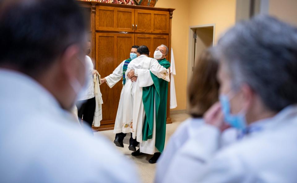 Monsignor Arturo J. Bañuelas, right, hugs his friend and fellow priest before his last Mass as pastor at Saint Mark’s Catholic Church, in El Paso, Texas, Sunday, July 10, 2022.