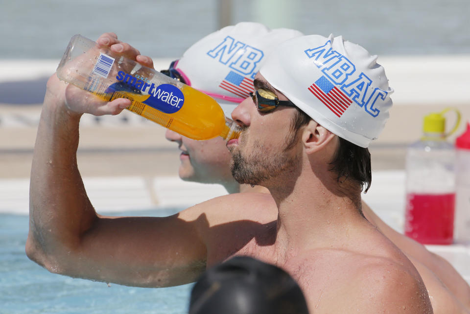 Michael Phelps warms up prior to competing in the 100 Butterfly during the Arena Grand Prix at Mesa, Thursday, April 24, 2014, in Mesa, Ariz. It is Phelps' first competitive event after a nearly two-year retirement. (AP Photo/Matt York)