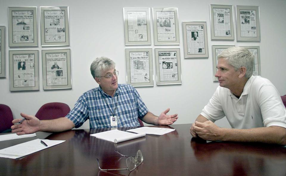 Ledger Sports Editor John Valerino, left, talks with former FSC Basketball Coach and Orlando Magic Assistant Coach George Scholz in 1999.
