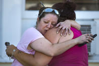 <p>Carrie Matula hugs a woman who lost her father in a mass shooting at the First Baptist Church in Sutherland Springs, Texas, Nov. 5, 2017. Matula said she saw and heard everything as it happened from the gas station where she works just a block away. (Nick Wagner / American-Statesman via AP) </p>