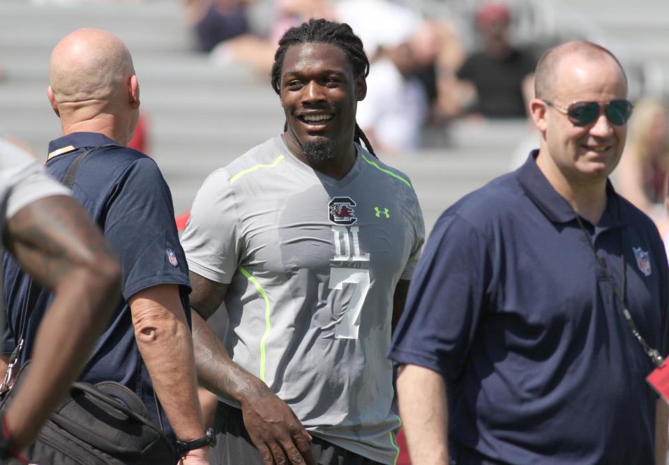 South Carolina defensive end Jadeveon Clowney, center, talks during South Carolina's pro day in Columbia, S.C., Wednesday, April 2, 2014. (AP Photo/Mary Ann Chastain)