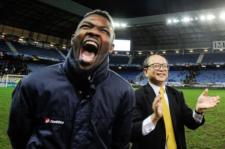 Sochaux owner Li Wing-Sang (R) celebrates with forward Marcus Thuram (L) at the end of the French cup round of 8 football match against Monaco, on February 9, 2016