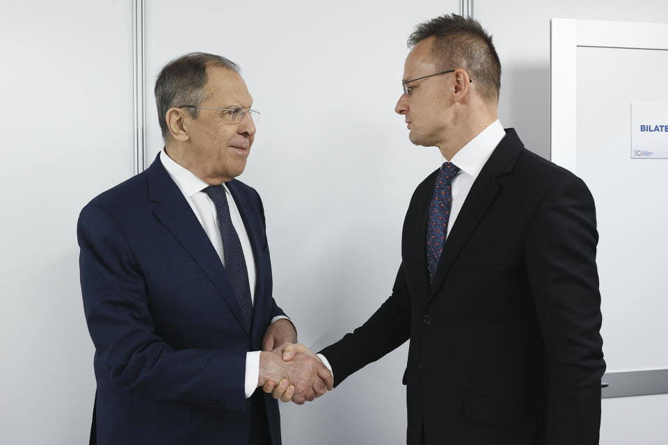In this photo released by Russian Foreign Ministry Press Service, Russian Foreign Minister Sergey Lavrov, left, shakes hands with Hungarian Minister of Foreign Affairs and Trade Peter Szijjarto on the sidelines of the OSCE (Organization for Security and Co-operation in Europe) Ministerial Council meeting, in Skopje, North Macedonia, on Thursday, Nov. 30, 2023. (Russian Foreign Ministry Press Service via AP)