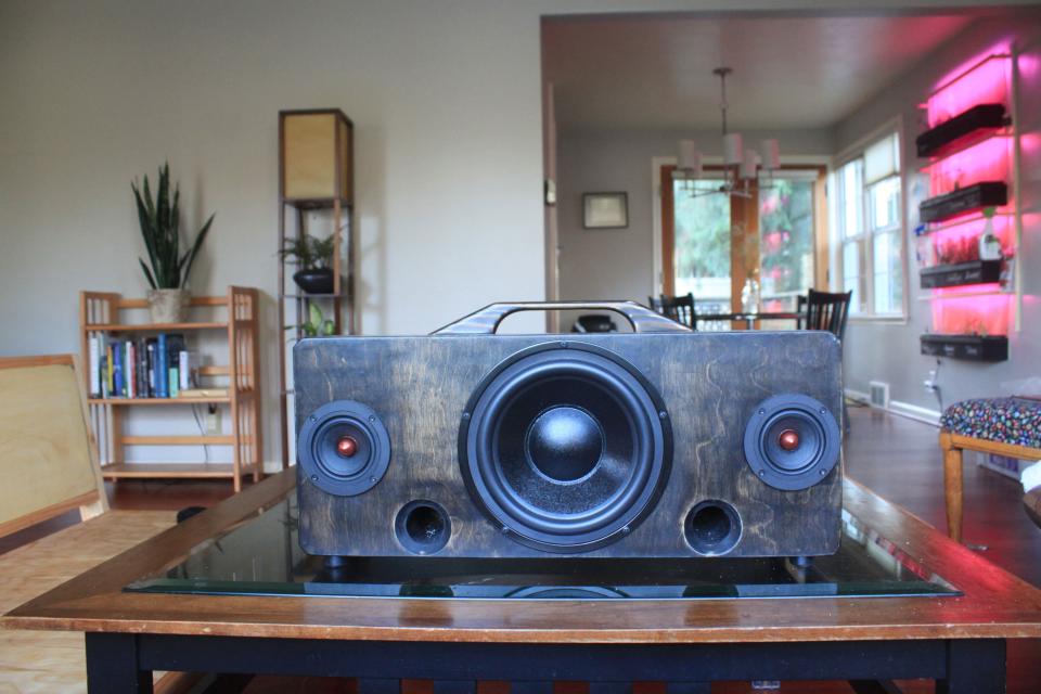 Laush crafted the speaker, coffee table, and vertical garden seen in the background.