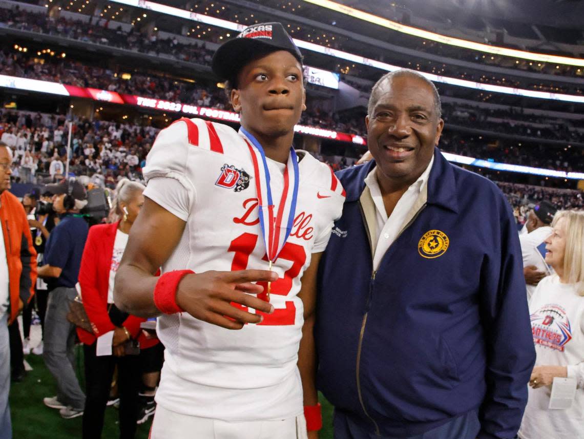 Duncanville quarterback Keelon Russell (12) poses with District 23 Senator Royce West after the UIL Conference 6A Division 1 state championship football game at AT&T Stadium in Arlington, Texas, Saturday, Dec. 16, 2023.