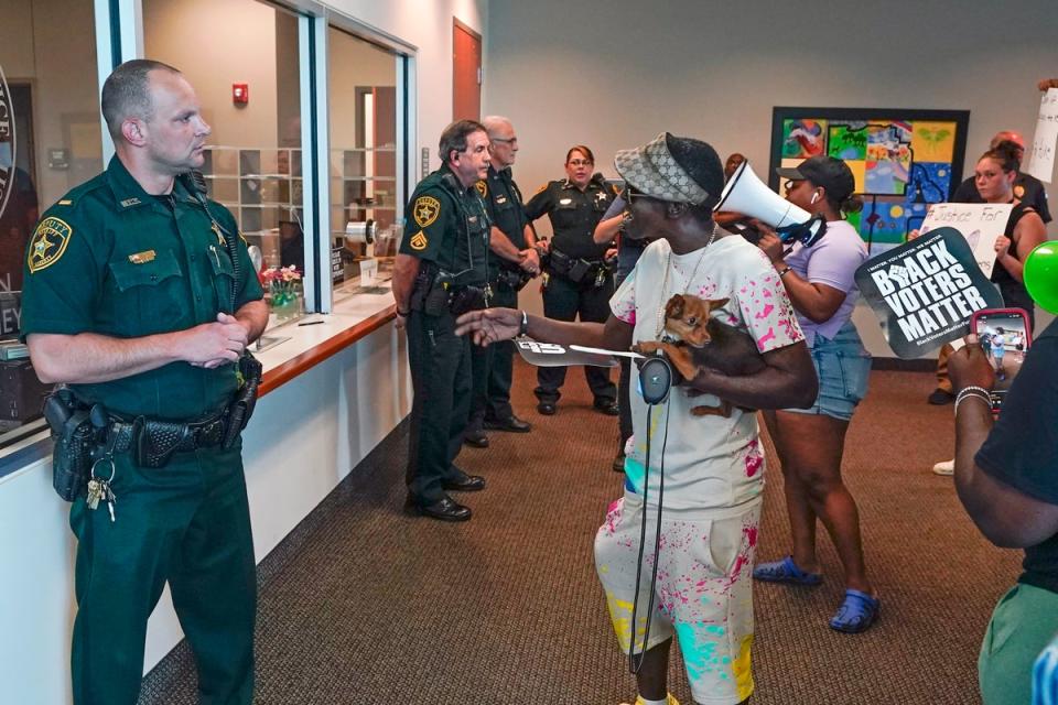 Protesters confront Marion County sheriff deputy's at the Marion County Courthouse (AP)