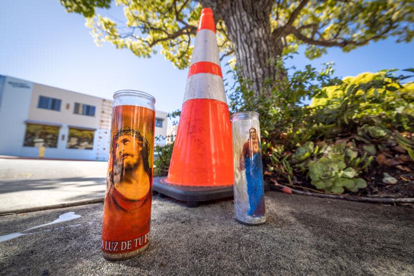 Redondo Beach, CA - April 09: A small candle memorial out front of where woman crashed her Porsche into a tree near the corner of PCH and Vincent Street in front of Saint James Catholic Church in Redondo beach, killing herself, this was after she killed her husband and left her two kids on the freeway. Police spent Monday following a bizarre and tragic trail of violence that left the dead and injured bodies of a Woodland Hills family scattered across Los Angeles County. The horror began with a woman killing her husband at their Valley home, abandoning her two small daughters on the 405 Freeway - one of whom died - and then fatally crashing her car into a tree in Redondo Beach, according to a law enforcement source who was not authorized to speak publicly about the investigation. Photo taken in in Redondo Beach Tuesday, April 9, 2024. (Allen J. Schaben / Los Angeles Times)