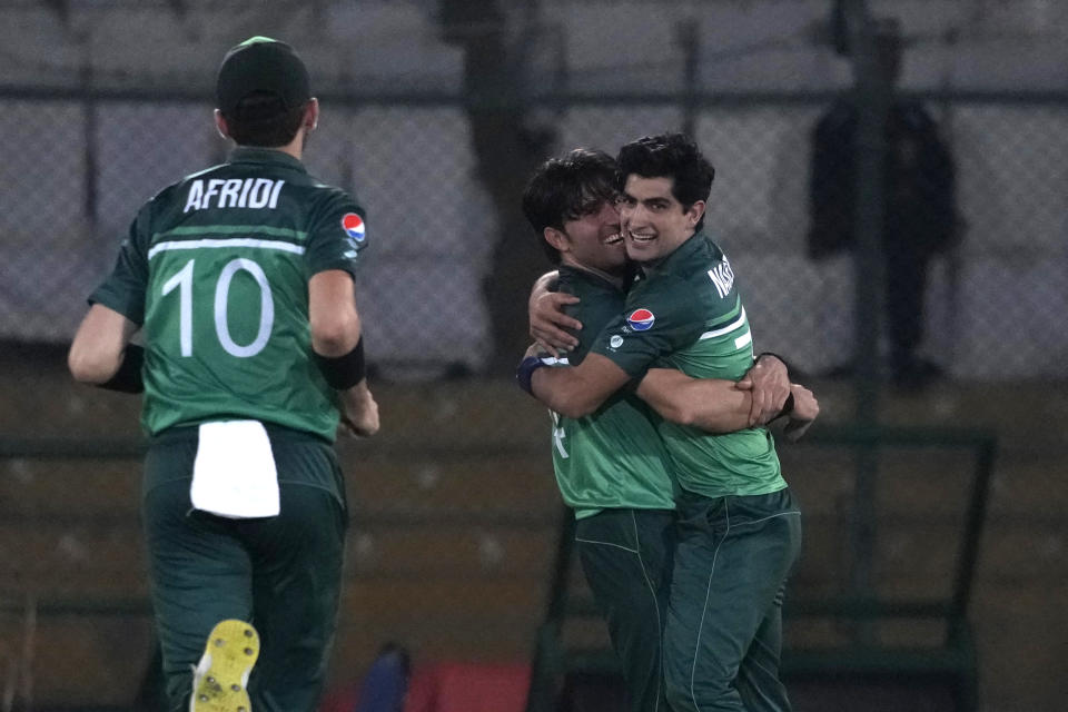 Pakistan's Naseem Shah, right, celebrates with teammate after taking the wicket of New Zealand's Mark Chapman during the third one-day international cricket match between Pakistan and New Zealand, in Karachi, Pakistan, Wednesday, May 3, 2023. (AP Photo/Fareed Khan)