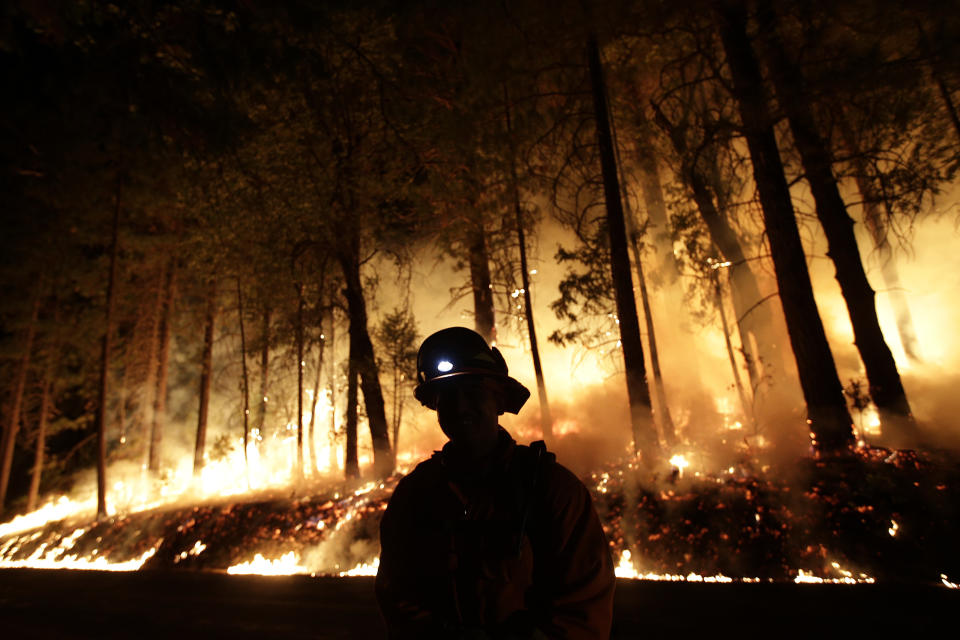 A firefighter watches for spot fires during a burnout operation while battling the Rim Fire near Yosemite National Park, Calif., on Sunday, Aug. 25, 2013. Fire crews are clearing brush and setting sprinklers to protect two groves of giant sequoias as a massive week-old wildfire rages along the remote northwest edge of Yosemite National Park. (Jae C. Hong/AP)