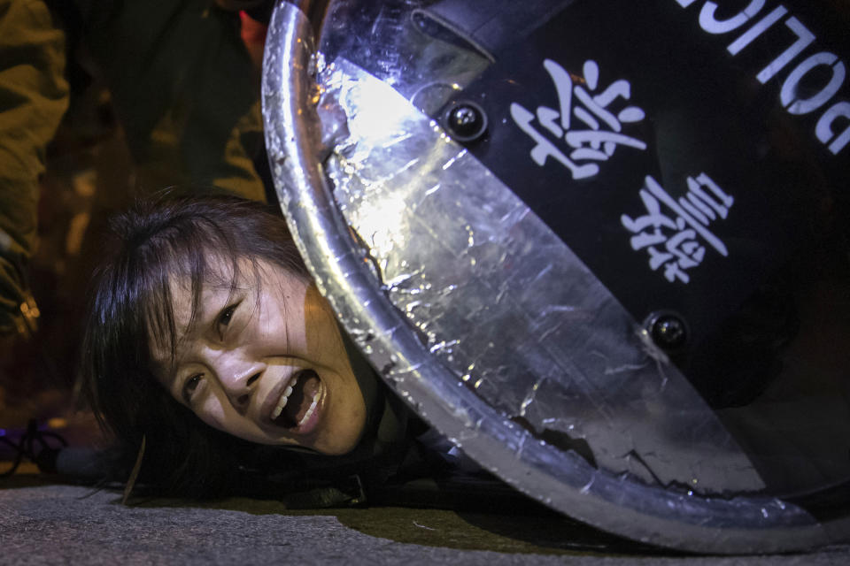 This Sept. 2, 2019 photo by Reuters photographer Tyrone Siu, provided by Columbia University, shows an anti-extradition bill protester detained by riot police during skirmishes between the police and protesters outside Mong Kok police station, in Hong Kong, China. The photography staff of Reuters was awarded the 2020 Pulitzer Prize for Breaking News Photography, in New York, Monday May 4, 2020, for wide-ranging and illuminating photographs of Hong Kong as citizens protested infringement of their civil liberties and defended the region's autonomy by the Chinese government. (Courtesy of Reuters via AP)