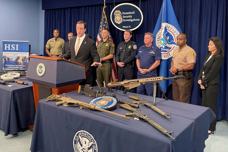 Seized weapons are displayed during a news conference in Miami