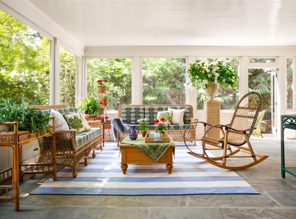 a sunroom with wicker furniture