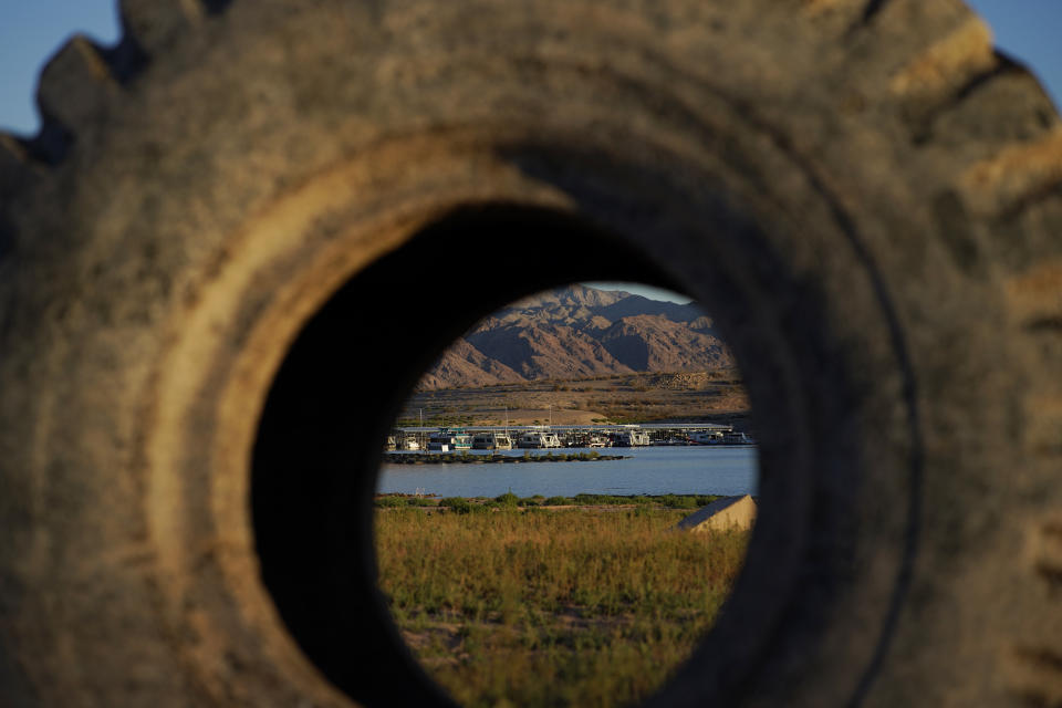 A truck tire once in the water as part of a marina sits on dry ground as water levels have dropped near the Callville Bay Resort & Marina in the Lake Mead National Recreation Area, Tuesday, Aug. 30, 2022, near Boulder City, Nev. In November 1922, seven land-owning white men brokered a deal to allocate water from the Colorado River, which winds through the West and ends in Mexico. During the past two decades, pressure has intensified on the river as the driest 22-year stretch in the past 1,200 years has gripped the southwestern U.S. (AP Photo/John Locher)