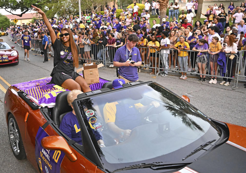 FILE - LSU forward Angel Reese waves to fans as the women's NCAA college national champion basketball team paraded across campus in Baton Rouge, La., Wednesday, April 5, 2023. Angel Reese is still getting used to the idea that celebrity athletes and entertainers she's long wanted to meet are interested in meeting her, too -- and thanking her for how she's elevated women's basketball.(Hilary Scheinuk/The New Orleans Advocate via AP, File, File)