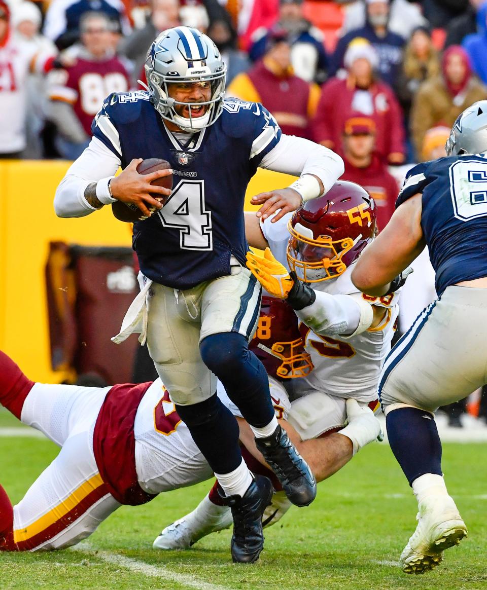 Cowboys quarterback Dak Prescott breaks a tackle against Washington in Week 14's win. Prescott hasn't been lighting up fantasy scoreboards, but he should fare better against the Football Team this time around in Week 16.