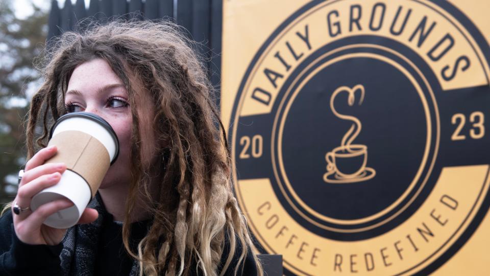 Olivia Atkinson of Gloucester City takes a sip of coffee as she sits outside of Daily Grounds coffee shop in Wenonah on Friday, December 1, 2023.