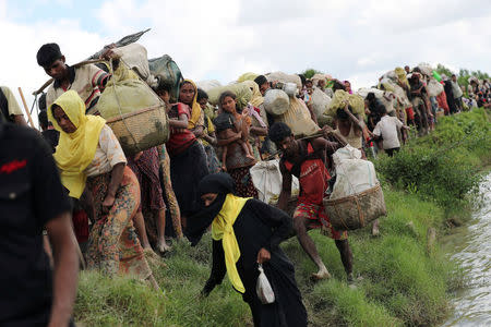 Rohingya refugees walk after crossing the border in Palang Khali, Bangladesh, October 9, 2017. REUTERS/Mohammad Ponir Hossain