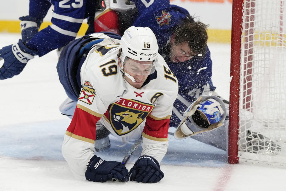 Florida Panthers left wing Matthew Tkachuk (19) crashes into Toronto Maple Leafs goaltender Joseph Woll as Leafs' Matthew Knies defends during the third period of an NHL hockey game in Toronto on Tuesday, Nov. 28, 2023. (Frank Gunn/The Canadian Press via AP)