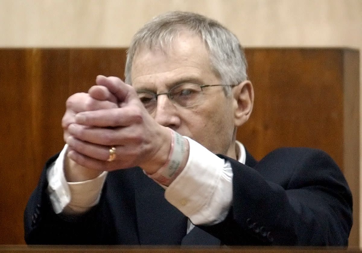 In 2003, Robert Durst went on trial for the murder of his neighbor Morris Black. Defense attorney Dick DeGuerin claimed that Durst killed Black out of self-defense. In this photo, Durst demonstrates how Morris Black handled a gun during a testimony at his trial on Oct. 23, 2003, in Galveston, Texas.