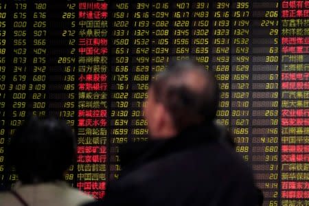 Investors look at an electronic board showing stock information at a brokerage house in Shanghai, China February 9, 2018. REUTERS/Aly Song