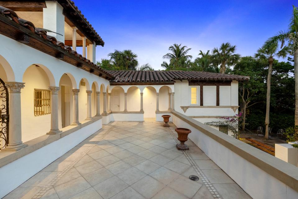 The second-floor cloister looks out to a broad terrace that doubles as a sundeck. “When its windy, we put a lounge chair on the sundeck, and you don’t get the wind — you get the sun,” says homeowner Jacques Cohen.