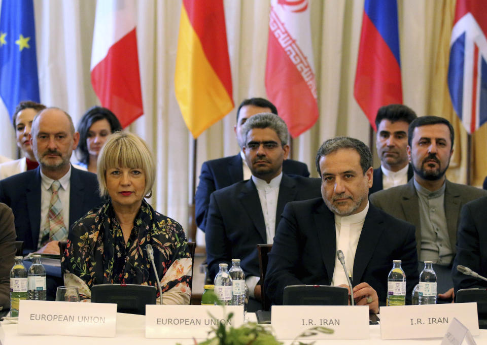 The European Union's political director Helga Schmid and Iran's deputy Foreign Minister Abbas Araghchi, from left, wait for a bilateral meeting as part of the closed-door nuclear talks with Iran at a hotel in Vienna, Austria, Sunday, July 28, 2019.