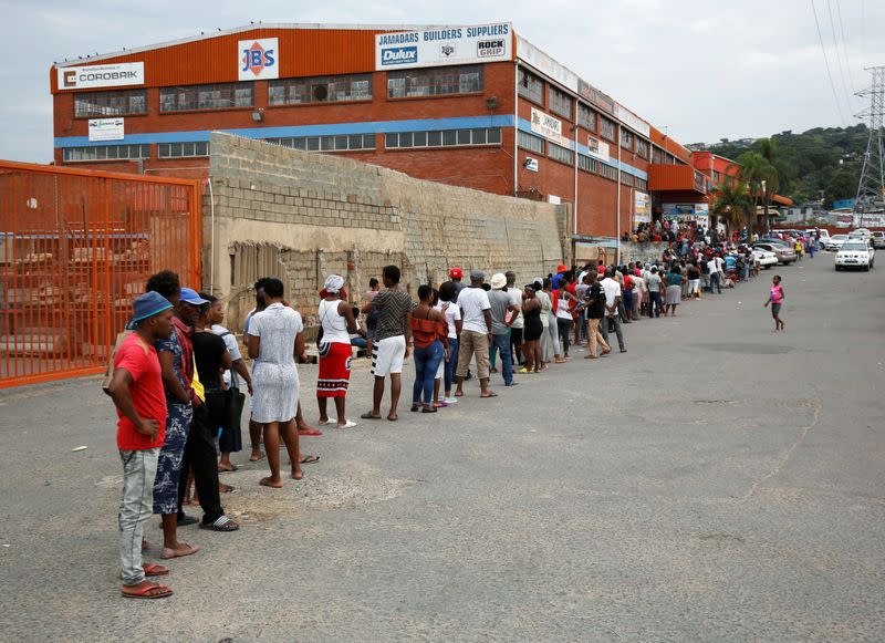 Shoppers queue at a grocery store during a nationwide 21 day lockdown in an attempt to contain the coronavirus disease (COVID-19) outbreak in Umlazi township near Durban