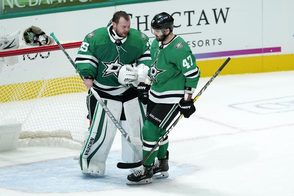 Dallas Stars goaltender Anton Khudobin (35) and right wing Alexander Radulov (47) celebrate after Radulov scored during the second period of the team's NHL hockey game against the Nashville Predators in Dallas, Friday, Jan. 22, 2021. The goal was the second in the night for Radulov. (AP Photo/Tony Gutierrez)