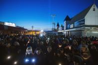 Residents of New Jersey take part in a "Light The Shore" event on the one year anniversary of the landfall of Hurricane Sandy in Seaside Heights, New Jersey October 29, 2013. A year after Superstorm Sandy inundated the East Coast with record flooding that left 159 people dead, residents of hard-hit New Jersey and New York shore communities still have a ways to go in rebuilding damaged homes. REUTERS/Lucas Jackson (UNITED STATES - Tags: DISASTER ENVIRONMENT ANNIVERSARY)