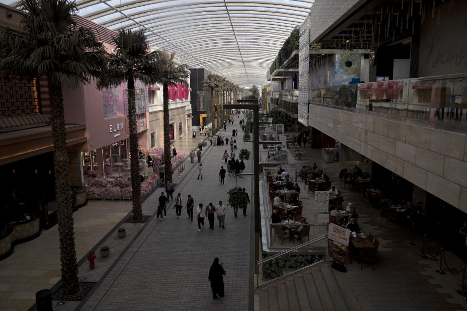 Shoppers stroll through The Avenues Mall in Kuwait City, Feb. 11, 2022. Kuwait is ranked each year as among the hottest places on the planet. Last summer, birds dropped dead from the sky and shellfish baked to death in the bay. Yet Kuwait stayed silent as the rest of the region’s wealthy petrostates joined a chorus of nations setting climate goals ahead of last fall’s U.N. climate summit in Glasgow. (AP Photo/Maya Alleruzzo)