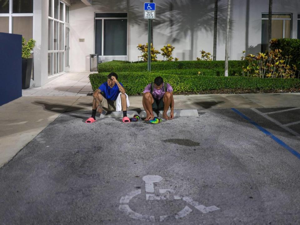 Franklin Pereira, 27, right, and Pedro Escalona were out in the street after losing both their jobs in the hurricane recovery zone in Fort Myers and their room at the Best Western in Doral, Florida. The Venezuelan migrants were recruited from a shelter in New York to work on hurricane cleanup.