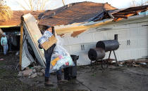 Mario Mendoza carries items out of a friend's storm-damaged home Tuesday, Jan. 24, 2023, in Pasadena, Texas. A powerful storm system took aim at Gulf Coast Tuesday, spawning tornados that caused damage east of Houston. (AP Photo/David J. Phillip)