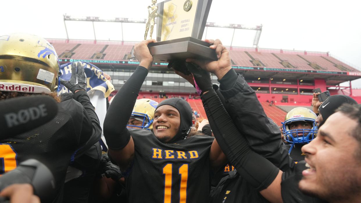 JaBron Solomon (11) of Woodbury holding the trophy at the end of the game as Woodbury defeated Mountain Lakes 31-7 to win the NJSIAA Group 1 Football Championship played in SHI Stadium at Rutgers in Piscataway, NJ in December 3,  2022.
