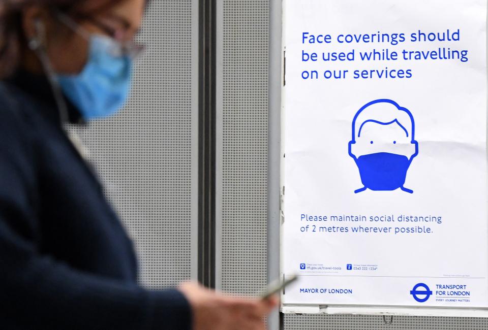 A sign tells commuters that they need to wear PPE (personal protective equipment) of a face covering, or mask, and observe social distancing as a precautionary measure against COVID-19, at Westminster underground station in central London on May 13, 2020, as people start to return to work after COVID-19 lockdown restrictions were eased. - Britain's economy shrank two percent in the first three months of the year, rocked by the fallout from the coronavirus pandemic, official data showed Wednesday, with analysts predicting even worse to come. Prime Minister Boris Johnson began this week to relax some of lockdown measures in order to help the economy, despite the rising death toll, but he has also stressed that great caution is needed. (Photo by DANIEL LEAL-OLIVAS / AFP) (Photo by DANIEL LEAL-OLIVAS/AFP via Getty Images)