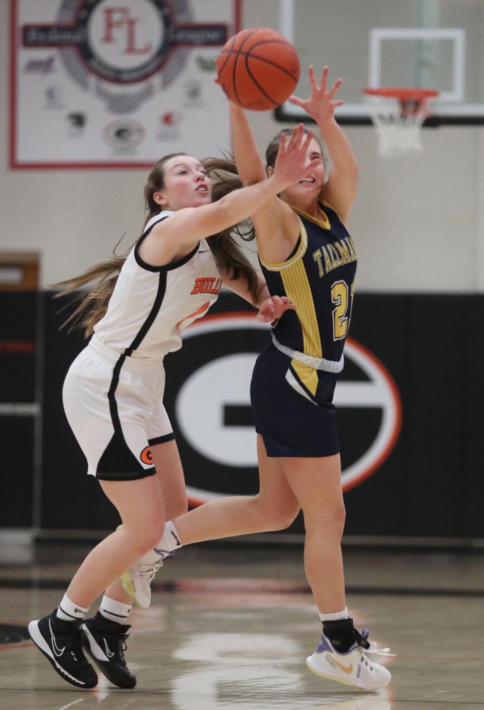 Green's Madi Pukansky tries to steal a pass as Tallmadge's Mia Zappola catches the ball in the first half Wednesday night at Green High School. Green won 72-28. [Mike Cardew/Akron Beacon Journal]