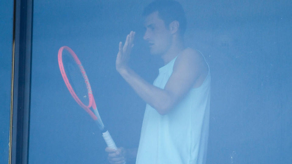 Bernard Tomic, pictured here exercising in his hotel room in Melbourne.