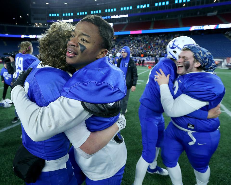 Scituate’s D’Kari Rodrigues hugs Keegan Sullivan following their 14-13 win over Duxbury in the Division 4 state title game at Gillette Stadium on Friday, Dec. 3, 2021.