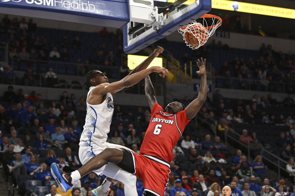 Saint Louis' Kellen Thames, left, dunks on Dayton's Enoch Cheeks during the second half of an NCAA college basketball game Tuesday, March 5, 2024, in St. Louis. (AP Photo/Joe Puetz)