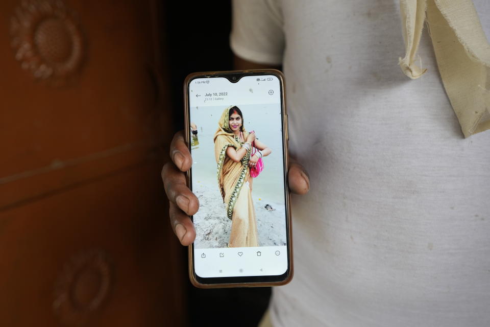 Sushil Kumar Bind displays a photograph of his wife Khushboo who was killed by lightning on July 25 in a paddy field at Piparaon village on the outskirts of Prayagraj, in the northern Indian state of Uttar Pradesh, Thursday, July 28, 2022. Seven people, mostly farmers, were killed by lightning in a village in India's northern Uttar Pradesh state, police said Thursday, bringing the death toll by lightning to 49 people in the state this week. (AP Photo/Rajesh Kumar Singh)